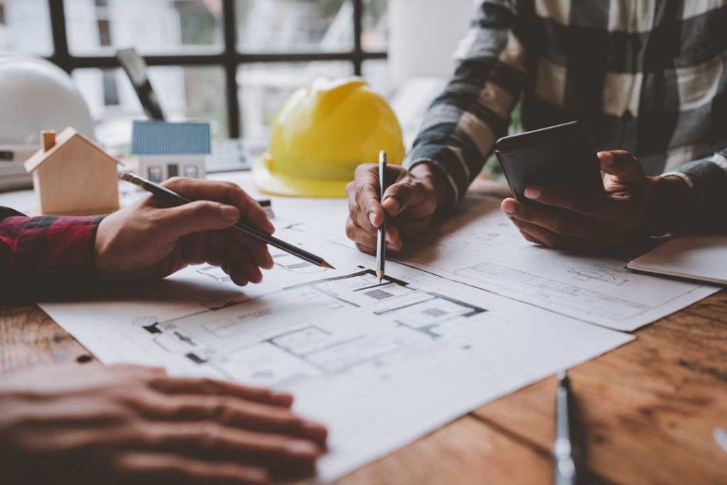 Structural Engineer Team Discussing And Calculating Work Office